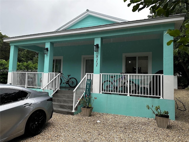 view of front of house with a porch and stucco siding