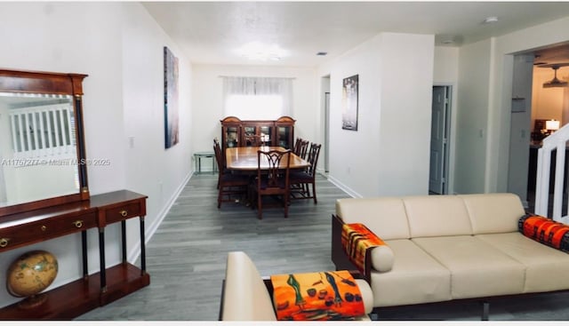 living area with wood finished floors and baseboards