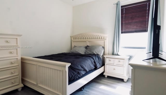 bedroom with dark wood-type flooring