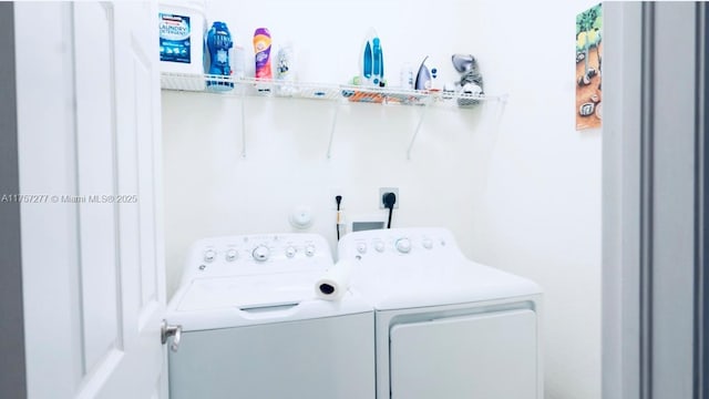 washroom featuring separate washer and dryer and laundry area