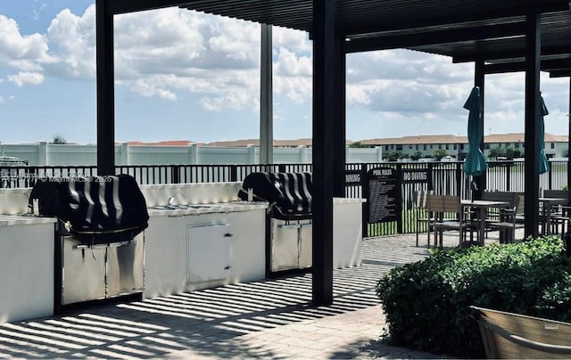 view of patio / terrace with fence and an outdoor kitchen