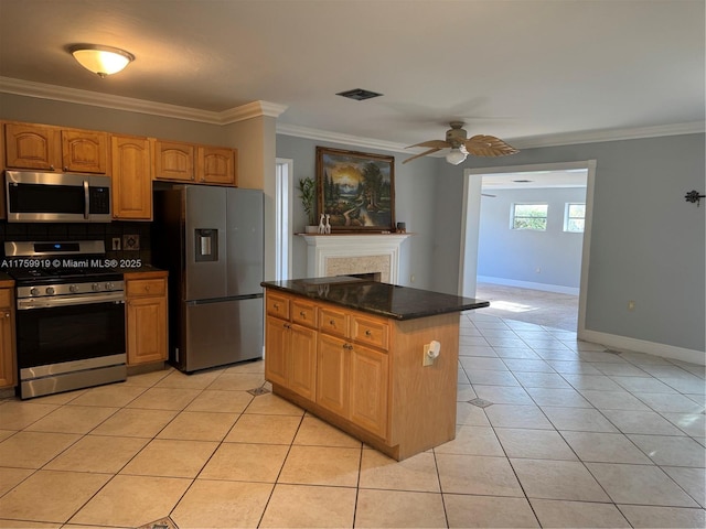 kitchen with crown molding, light tile patterned flooring, visible vents, and stainless steel appliances