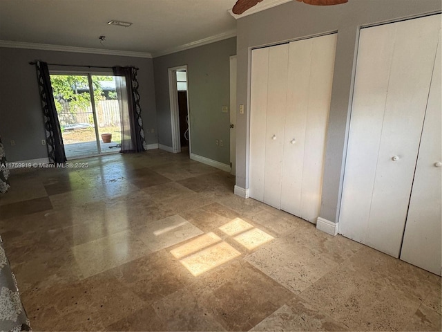 unfurnished bedroom with baseboards, two closets, access to exterior, crown molding, and tile patterned floors