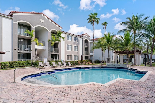 community pool with a patio area