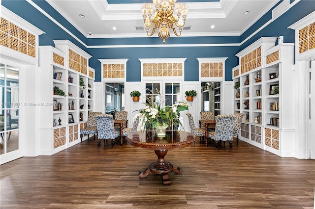 living area featuring an inviting chandelier, crown molding, wood finished floors, and french doors