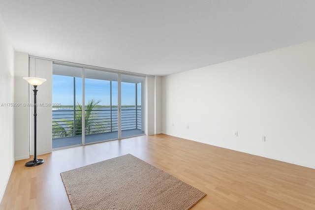 1175 NE Miami Gardens Dr Unit 610, Miami, FL 33179 - unfurnished room featuring wood finished floors and expansive windows
