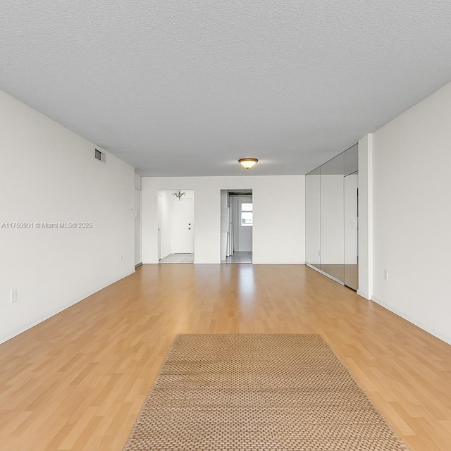 1175 NE Miami Gardens Dr Unit 610, Miami, FL 33179 - unfurnished room with light wood-style floors and a textured ceiling
