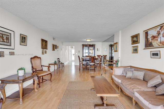 1175 NE Miami Gardens Dr Unit 610, Miami, FL 33179 - living area with light wood-type flooring and a textured ceiling