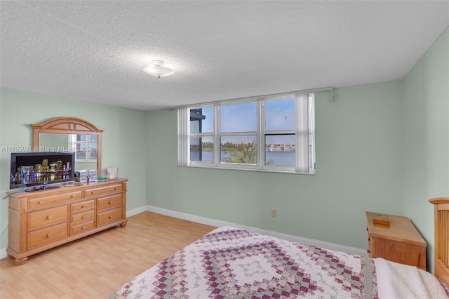 1175 NE Miami Gardens Dr Unit 610, Miami, FL 33179 - bedroom featuring light wood-style floors, baseboards, and a textured ceiling