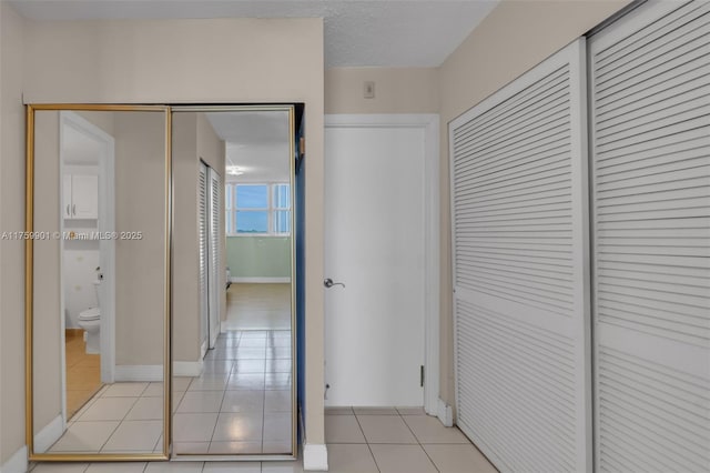 1175 NE Miami Gardens Dr Unit 610, Miami, FL 33179 - corridor featuring light tile patterned flooring and baseboards