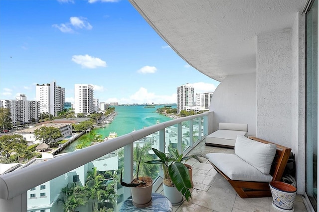 balcony with a water view and a city view