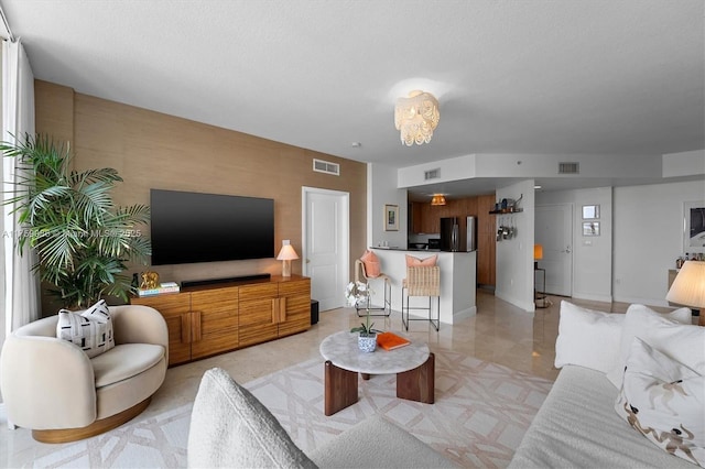 living area featuring visible vents and baseboards