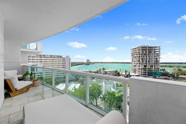 balcony featuring a city view and a water view