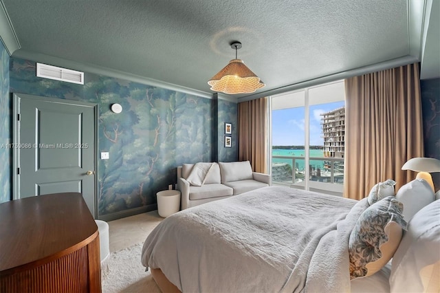 bedroom with wallpapered walls, carpet, visible vents, and a textured ceiling