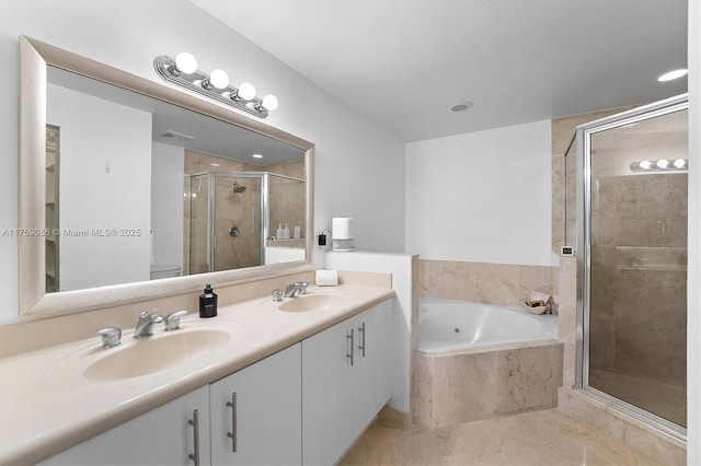 bathroom with a shower stall, a garden tub, double vanity, and a sink