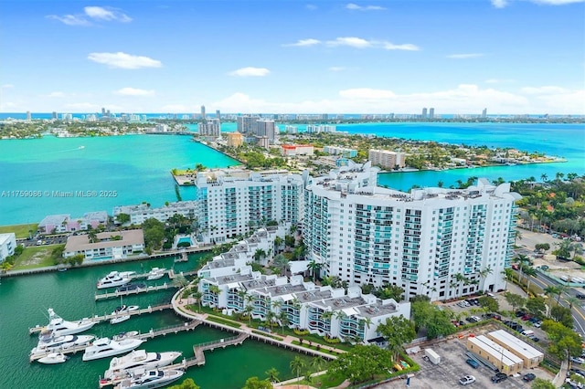 drone / aerial view featuring a water view and a city view