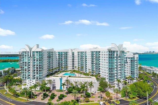 view of building exterior featuring a view of city and a water view