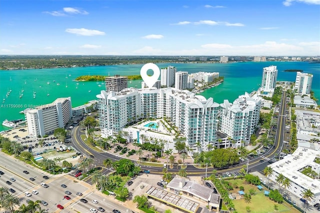 drone / aerial view featuring a view of city and a water view