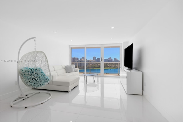 living area featuring tile patterned flooring, recessed lighting, and expansive windows