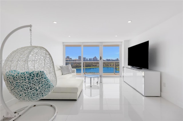 living area featuring tile patterned floors, recessed lighting, and floor to ceiling windows