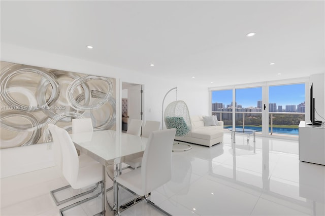 dining area with floor to ceiling windows and recessed lighting