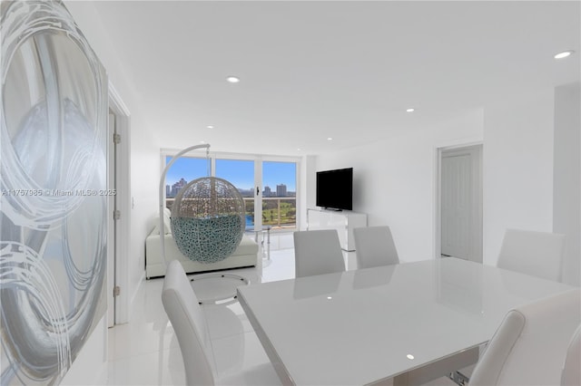 dining area featuring light tile patterned floors, recessed lighting, and expansive windows