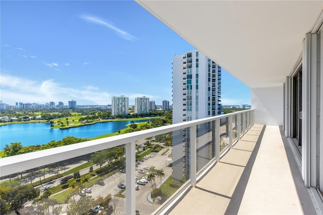 balcony featuring a water view and a city view