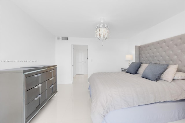 bedroom featuring visible vents and a notable chandelier