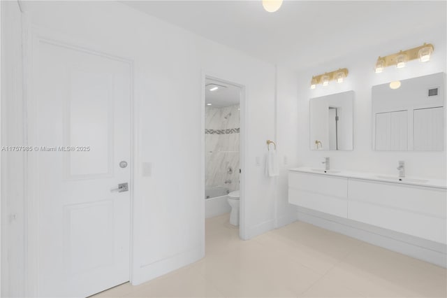 bathroom with visible vents, toilet, double vanity, shower / bathing tub combination, and a sink