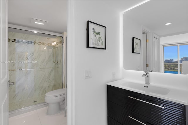 full bath with vanity, toilet, tile patterned flooring, and a marble finish shower