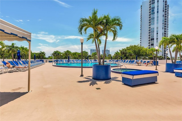 community pool featuring a patio and a community hot tub