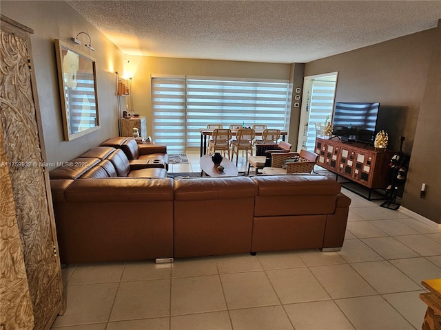 living area featuring light tile patterned floors and a textured ceiling