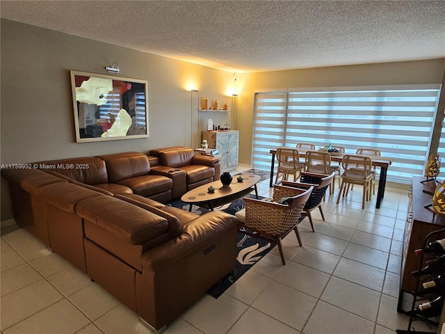 living area featuring light tile patterned floors and a textured ceiling