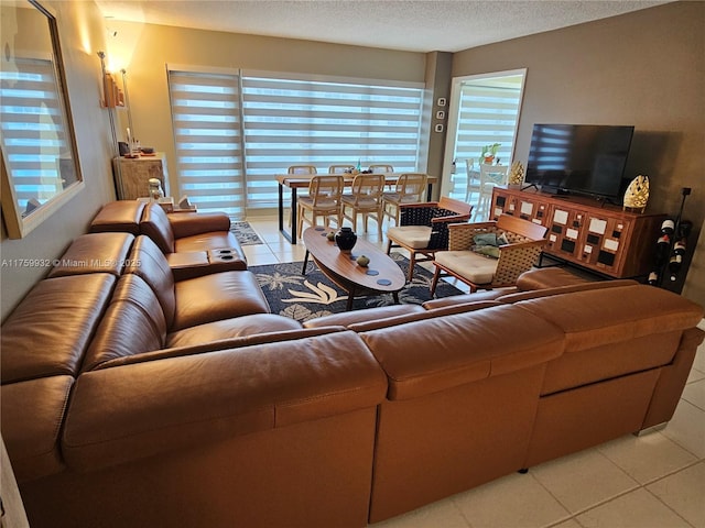 living room with a textured ceiling and light tile patterned flooring