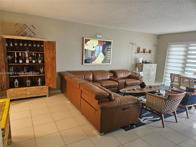 living room with a textured ceiling and light tile patterned flooring