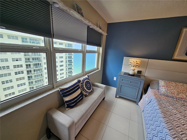 bedroom featuring light tile patterned flooring and a textured ceiling