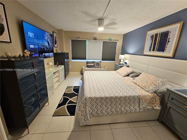 bedroom featuring light tile patterned floors, a textured ceiling, and ceiling fan