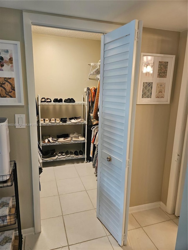 walk in closet featuring tile patterned flooring