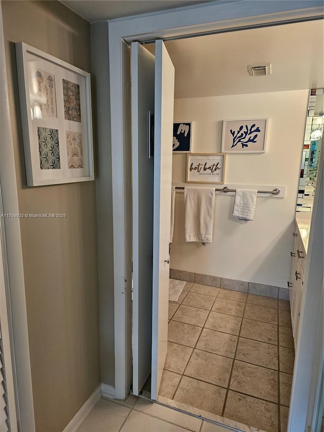 bathroom featuring tile patterned floors and baseboards