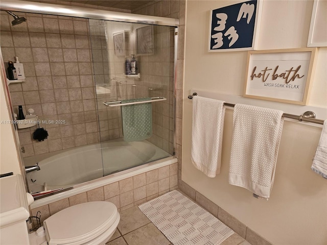 full bath featuring tile patterned floors, toilet, and tiled shower / bath