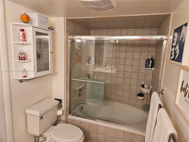 bathroom featuring visible vents, toilet, and tiled shower / bath