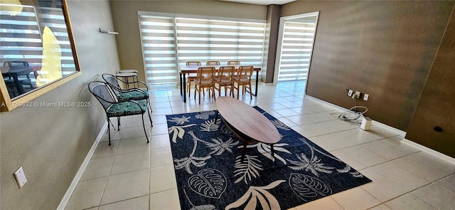 interior space featuring light tile patterned flooring and baseboards