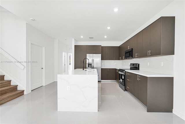 kitchen with an island with sink, recessed lighting, dark brown cabinetry, appliances with stainless steel finishes, and modern cabinets