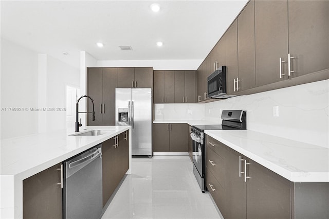 kitchen with visible vents, dark brown cabinetry, recessed lighting, appliances with stainless steel finishes, and a sink