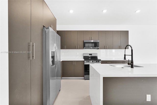 kitchen with stainless steel appliances, modern cabinets, and a sink