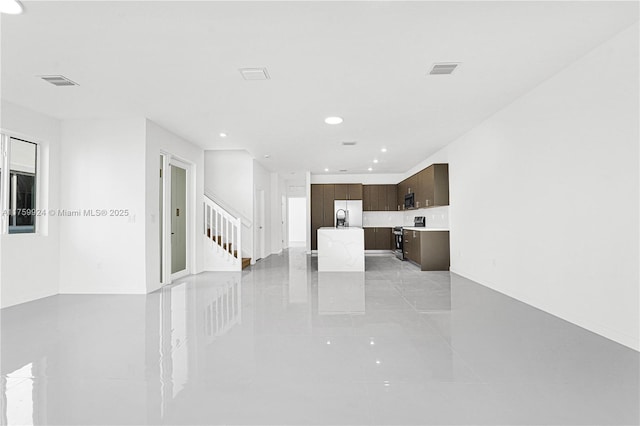 unfurnished living room with stairway, recessed lighting, and visible vents