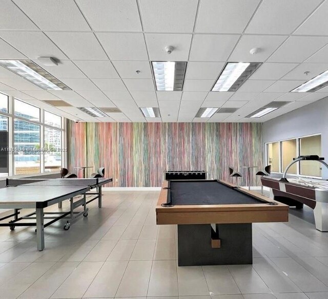 1200 Brickell Bay Dr Unit 3318, Miami, FL 33131 - rec room with wallpapered walls, pool table, an accent wall, a paneled ceiling, and light tile patterned flooring