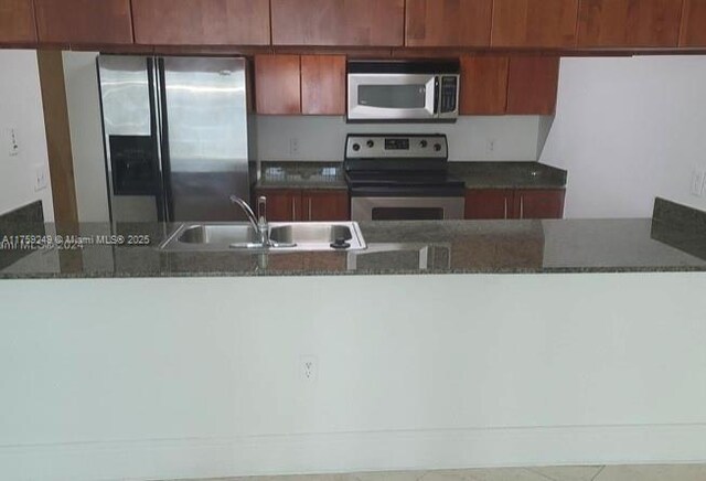 1200 Brickell Bay Dr Unit 3318, Miami, FL 33131 - kitchen with appliances with stainless steel finishes, a sink, and dark stone countertops