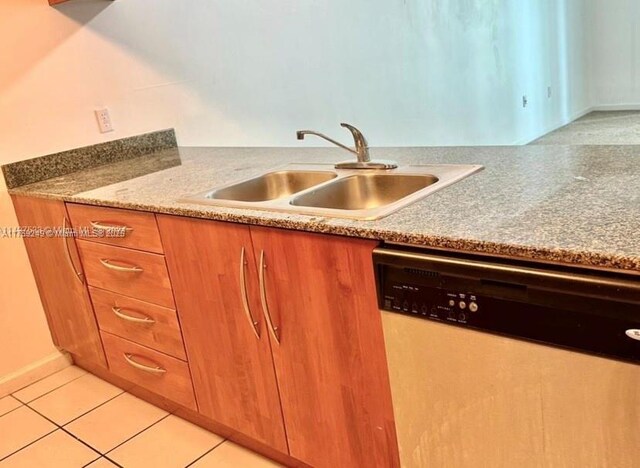 1200 Brickell Bay Dr Unit 3318, Miami, FL 33131 - kitchen featuring dishwasher, a sink, brown cabinets, light tile patterned floors, and light countertops