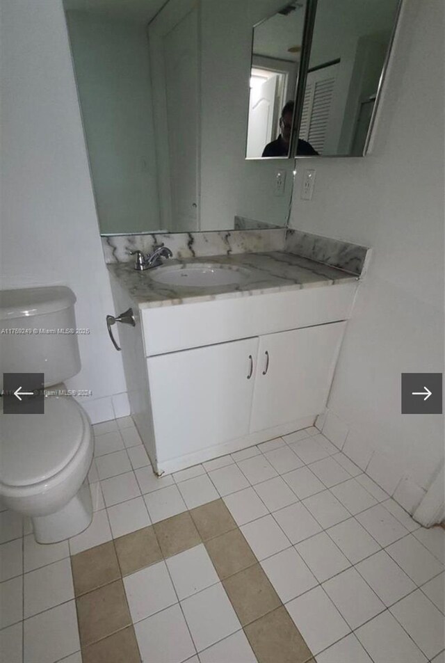 1200 Brickell Bay Dr Unit 3318, Miami, FL 33131 - bathroom featuring vanity, toilet, and tile patterned floors